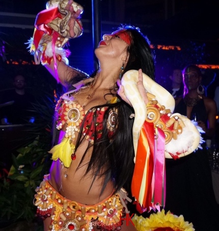 A Dancer in HK dancing with two snake at a cocktails event