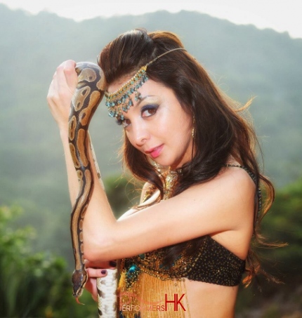 Close-up photo of beautiful Hong Kong snake charmer and her snake 