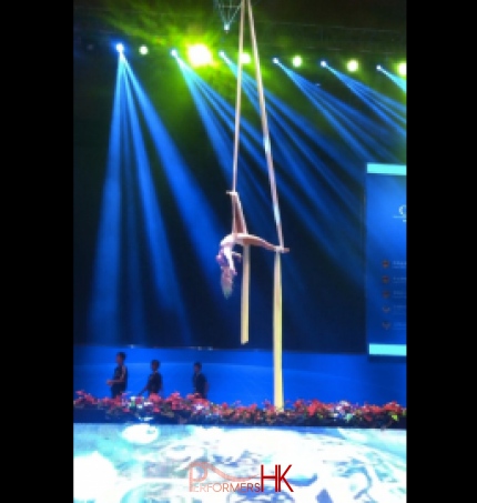 A Aerial Solo silk performer Perfect posing perfectly after a breathtaking drop at annual dinner in Hong Kong Convention and Exhibition Centre