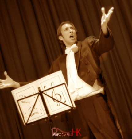 A Kong Kong stage magician performing his comedy musical magic show at a corporate annual dinner 