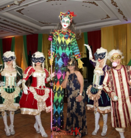 Hong Kong professional stiltwalker in Venetian LED costume posing with three Maries Marionette dancers and juggler at a corporate Masquerade theme annual dinner