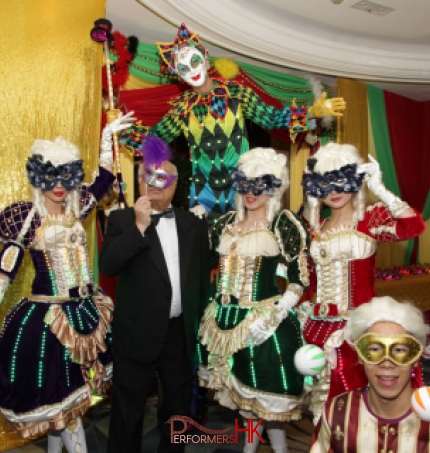 Stiltwalker in Venetian LED costume posing with three Maries Marionette dancers and juggler at a Hong Kong corporate Masquerade theme event