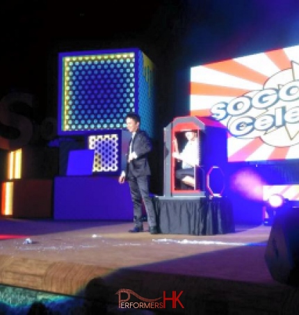 Magician performing stage magic with the audience inside the magic box at the Hong Kong SOGO 30th anniversary corporate dinner