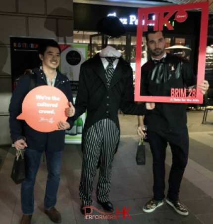 Headless man living state performing next to a cafe in a Hong Kong shopping mall