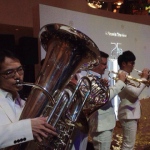 Brass band looks sharp performing in white suits.