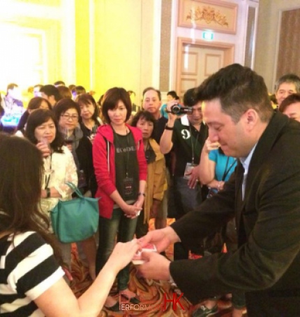 Walk around magician performing close up card magic and invited a guest to pick a card at a cocktails party in Hong Kong 