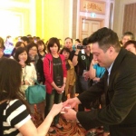 Walk around magician performing close up card magic and invited a guest to pick a card at a cocktails party in Hong Kong 