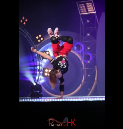 Hip hop dancer doing one arm hand stand for a dance show