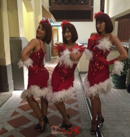 Three reindeer girls in red and white costumes posing at Christmas event in Hong Kong