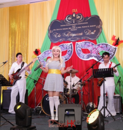 Band dressed in Abba clothing performing in hotel ballroom