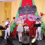 Band dressed in Abba clothing performing in hotel ballroom