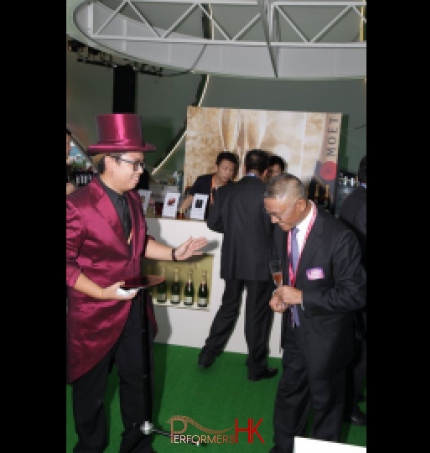 Magician performing a table magic trick at a corporate cocktail event in Hong Kong