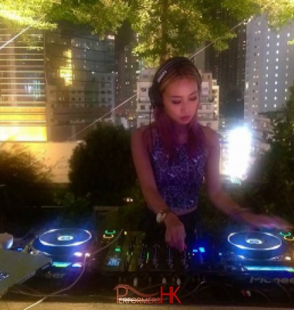DJ Bezi in Hong Kong with buildings in the background