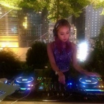 DJ Bezi spinning in front of skyscrapers in Hong Kong. 