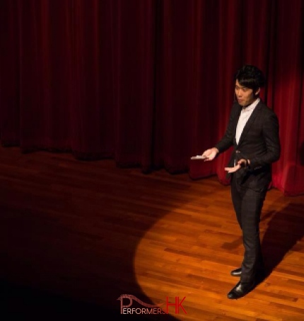 Hong Kong Magician performing stage magic with a spotlight on him at corporate annual dinner