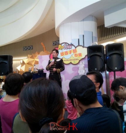 Magician performing stage magic with a mic at Hong Kong Shopping mall