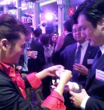 Hong Kong Magician performing roving card magic at DBS Hong Kong cocktail party 