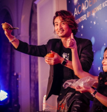 Hong Kong Magician impressed a guest by performing a stage magic with fruit at a corporate event