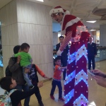 Showing off his amazing LED costume to a young patron at Citiplaza.