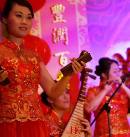 Three Hong Kong Chinese music musicians playing Chinese traditional instrument Bamboo Castanet , Pipa and Xiao at a New year event