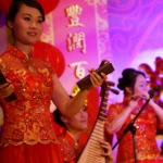 Three Hong Kong Chinese music musicians playing Chinese traditional instrument Bamboo Castanet , Pipa and Xiao at a New year event