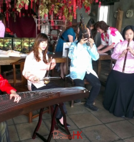 Four Chinese musicians in Hong Kong performing at a corporate Chinese theme event during Chinese new year