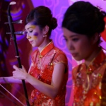 Erhu musicians performing lively Chinese music at a dinner event. 