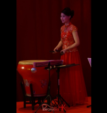 Chinese music musician in Hong Kong playing traditional instrument Bamboo Castanets behind the Chinese drum on the stage