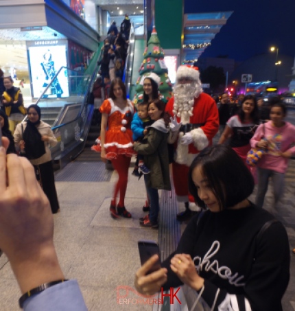Hong Kong Xmas performers in Santa ,Santa girl and Elf costumes taking pictures with the guests at Sogo Christmas function.