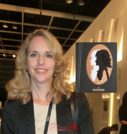 Business lady next to her portrait cutout at an exhibition