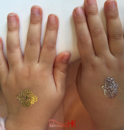 Two Sliver and gold henna temporary tattoos on hands