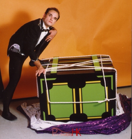 A HK professional magician stepping on a truck with tight with rope , ready to perform a corporate event