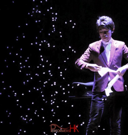 Magician in HK performing stage magic snow storm with white paper at corporate event.