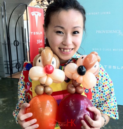 Clown holding two balloon chipmunk animals