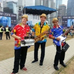 3 musicians in Hong Kong walk around performing at a summer event