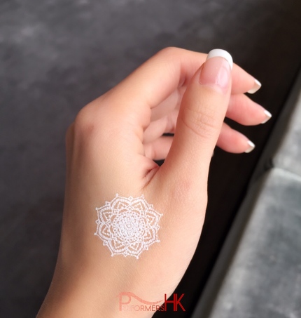 A white temporary henna tattoos on hand