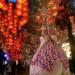 Giant Easter Bunny smiles at the camera with dozens of Chinese lanterns in the background. 