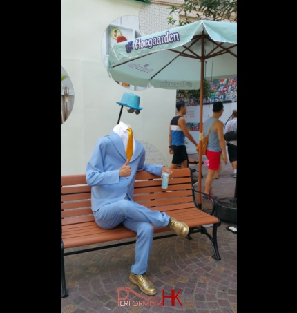 Hong Kong living statue performer in headless man costume at Lee Tung Avenue.