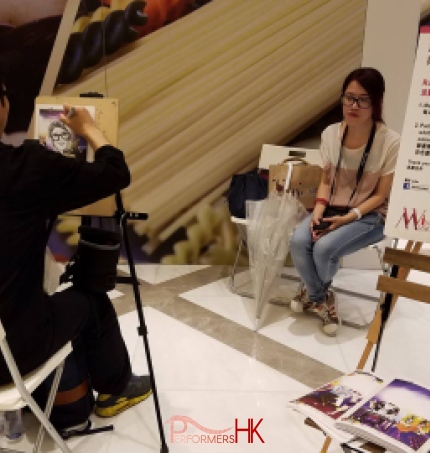 Girl waiting for her drawing to be done with Performers Hk Caricaturist