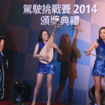 Musician with Chinese instrument pipa along with other traditional instruments performing western music at a Car show in China 