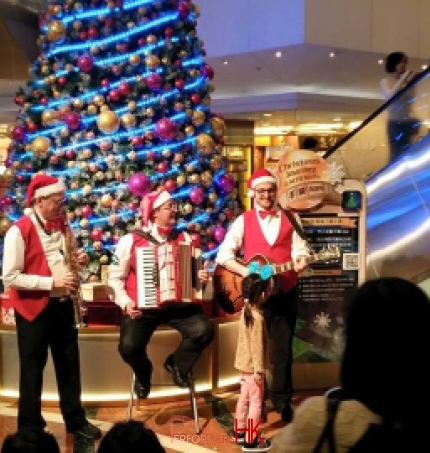 Accordion sax and guitar player during Xmas performing 