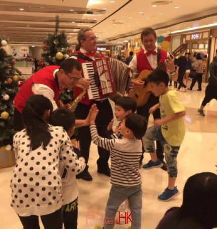 Musicians in red vest playing in mall in Hong Kong 2015