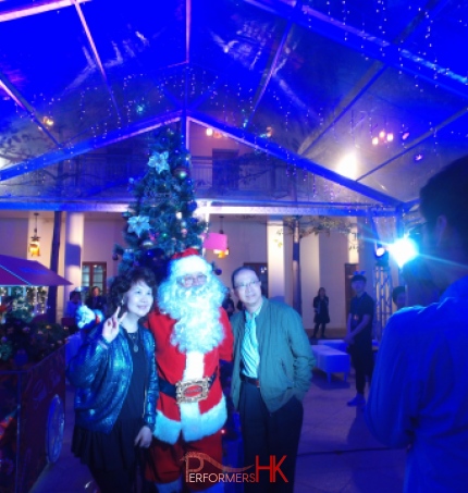 Santa taking photo in marquee.