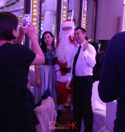 Santa John taking photo with 2 guests in wan chai