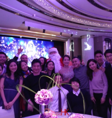 Santa John taking group photos with guests