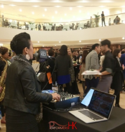 duo with lap top mixer and dj console. Pioneer djm 900, with mics and people at cocktail event