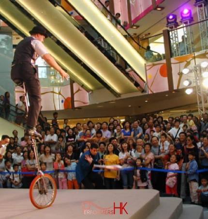 Performing riding a giraffe unicycle for a shopping centre show in SOGO hong kong