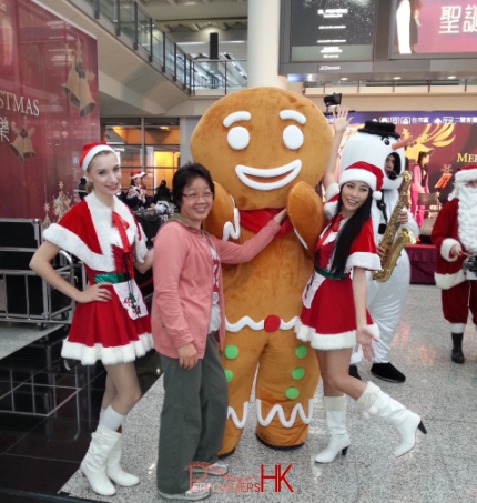 2 models standing with gingerbread man in Hong Kong