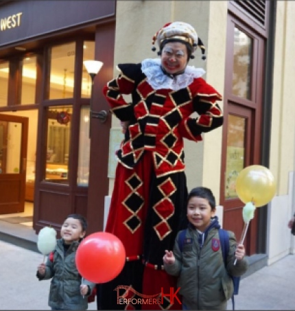 Stilt costume performer in the streets of hong kong performinhg