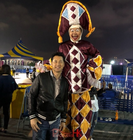 stilt performer with local hong kong celebrity michael wong